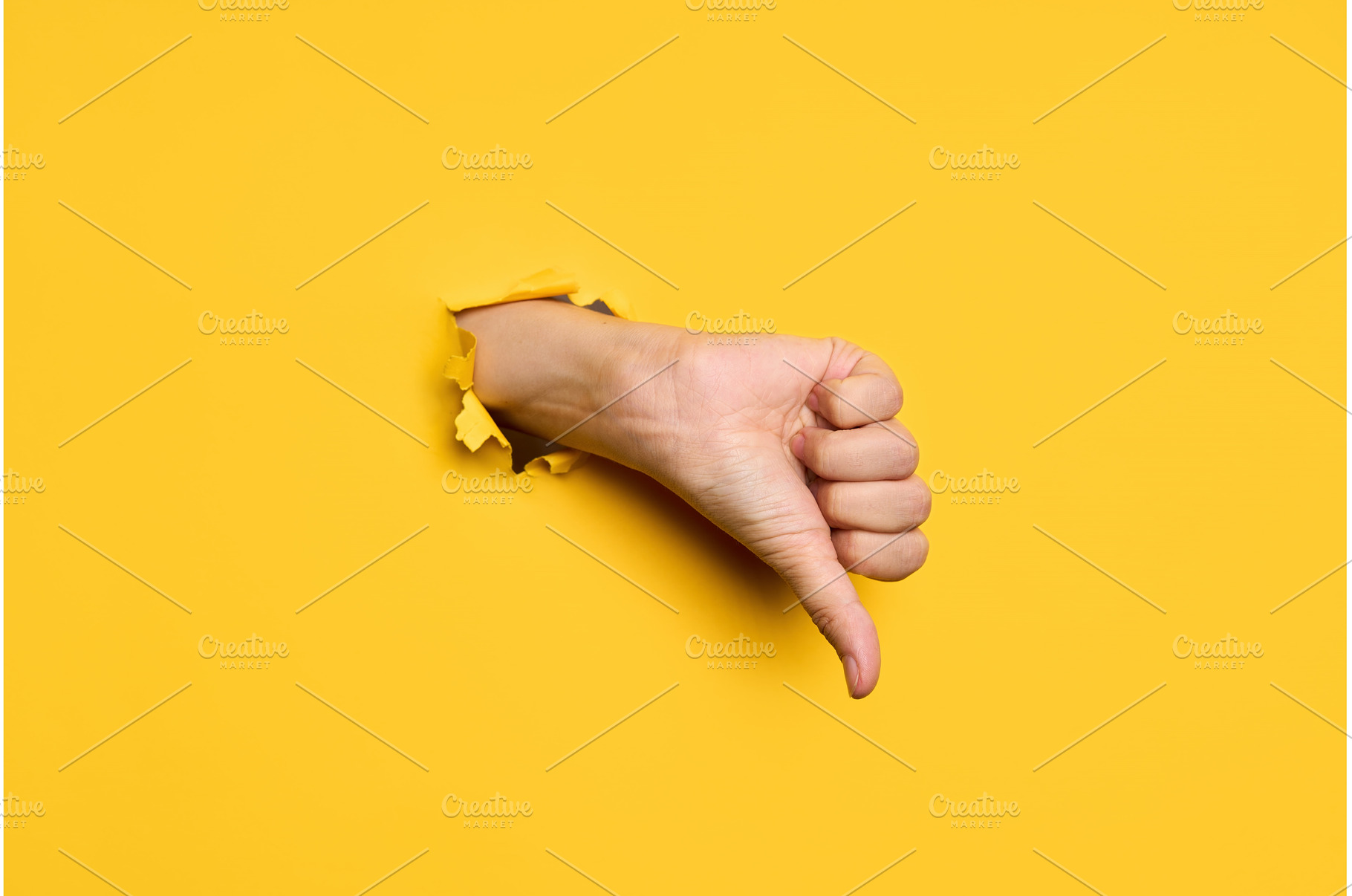 Thumb down sign gesture through hole, a Person Photo by Gladkov photography