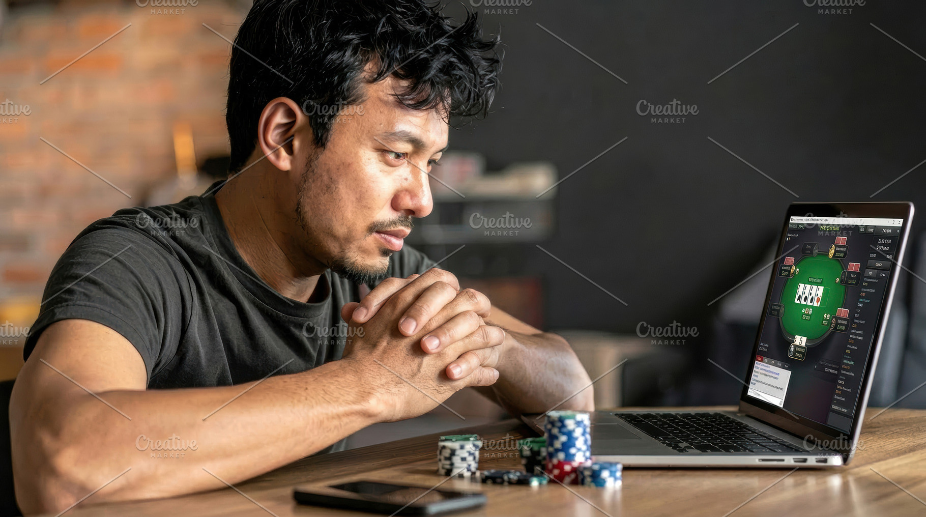 Focused man playing online poker on laptop, a Sports & Recreation Photo by Davizro's Market