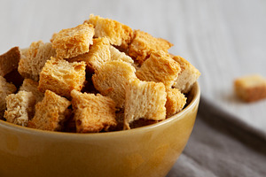 Homemade Crispy Bread Croutons in a Bowl, side view. Close-up., a Food & Drink Photo by LiudmylaChuhunova