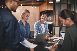 Diverse businesspeople working together around an office table