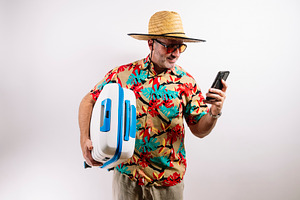 Traveler showing phone and holding blue suitcase, a Holiday Photo by karrastock