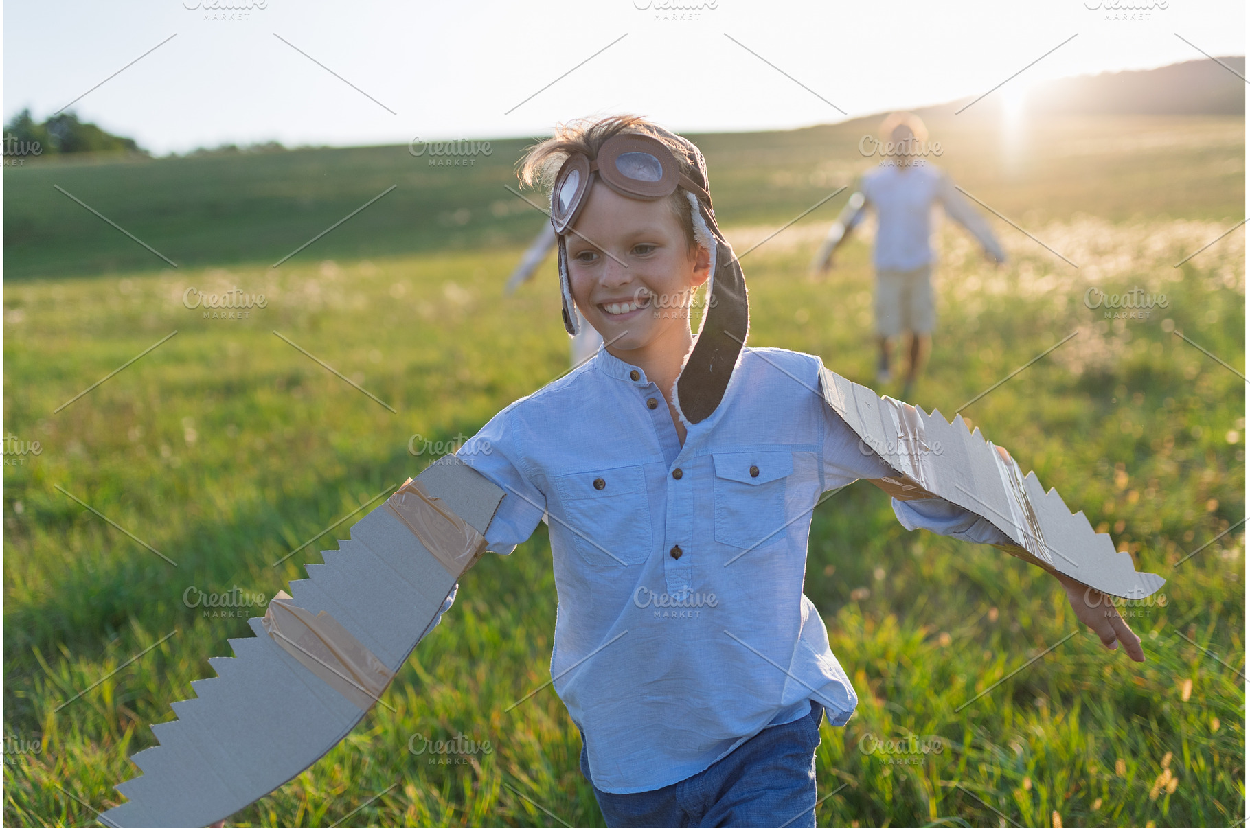 Child playing aviator in nature with, a Person Photo by HalfPoint