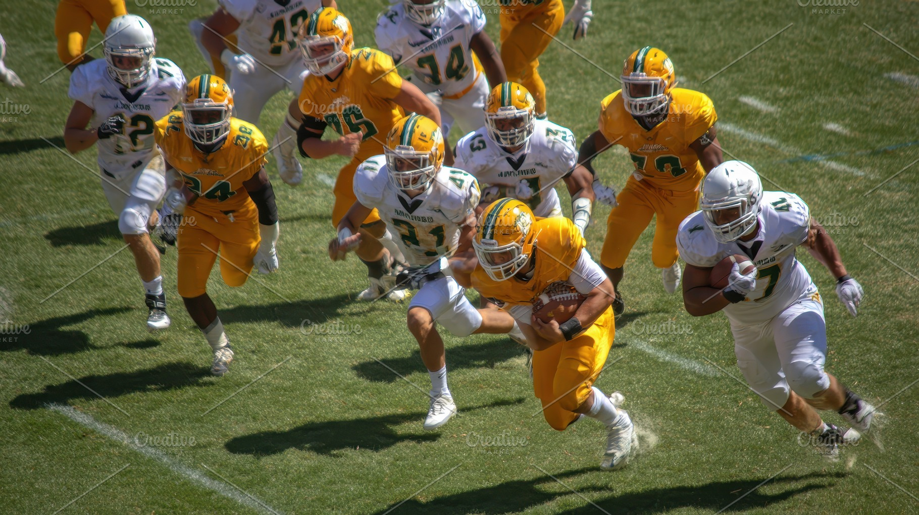 Football player running with the bal, a Photo by Pixeness Studio