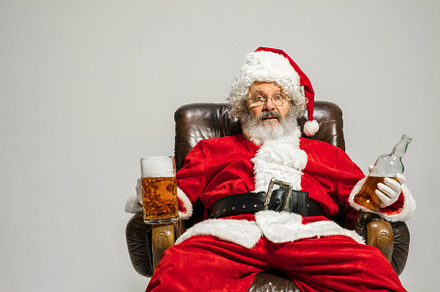 Santa claus drinking beer sitting on containing santa, claus, and bag, a Person Photo by Volodymyr Melnyk