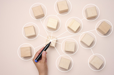 Wooden cubes are connected by lines on a beige background., a Business Photo by ndanko