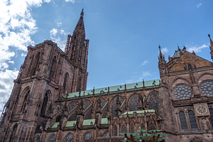 South side of Strasbourg Cathedral under blue sky, an Architecture Photo by GoodGoods