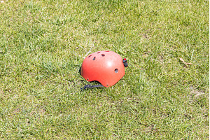 A red helmet on the green grass, a Technology Photo by Illustrations&photos