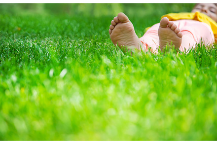 The child lies on the grass, a Person Photo by yanadjana