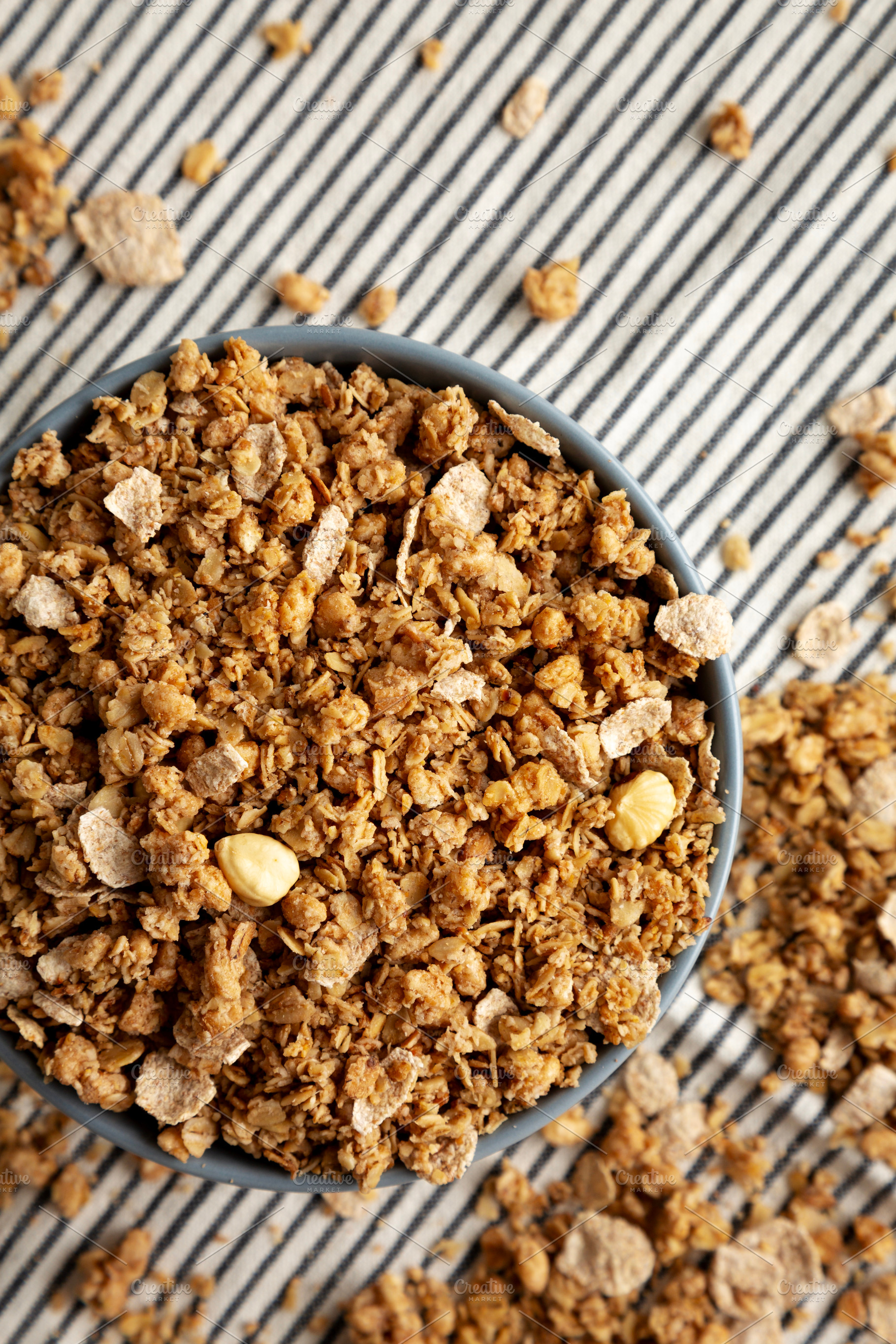 Healthy Homemade Toasted Muesli with Nuts in a Bowl, top view., a Food & Drink Photo by LiudmylaChuhunova
