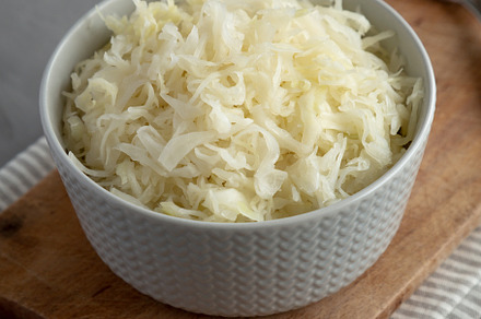 Homemade German Sauerkraut in a Bowl on a gray background, side, a Food & Drink Photo by LiudmylaChuhunova
