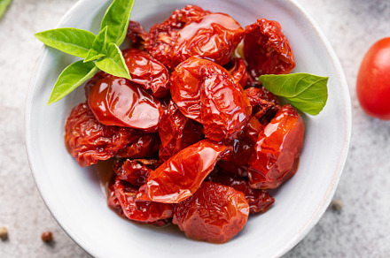 Bowl with sun dried tomatoes with fresh herbs and spices., a Food & Drink Photo by Olena Rudo