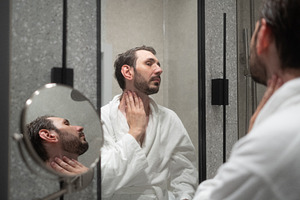 Man standing in his modern bathroom