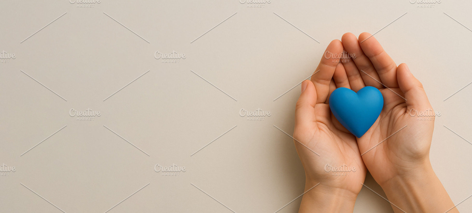 Men health awareness symbol, hands holding blue heart on beige b, a Photo by Dvoevnore photos