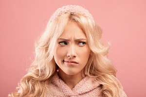 Upset thoughtful woman looking aside, imagining something, feeling doubtful or, a Photo by Prostock-Studio