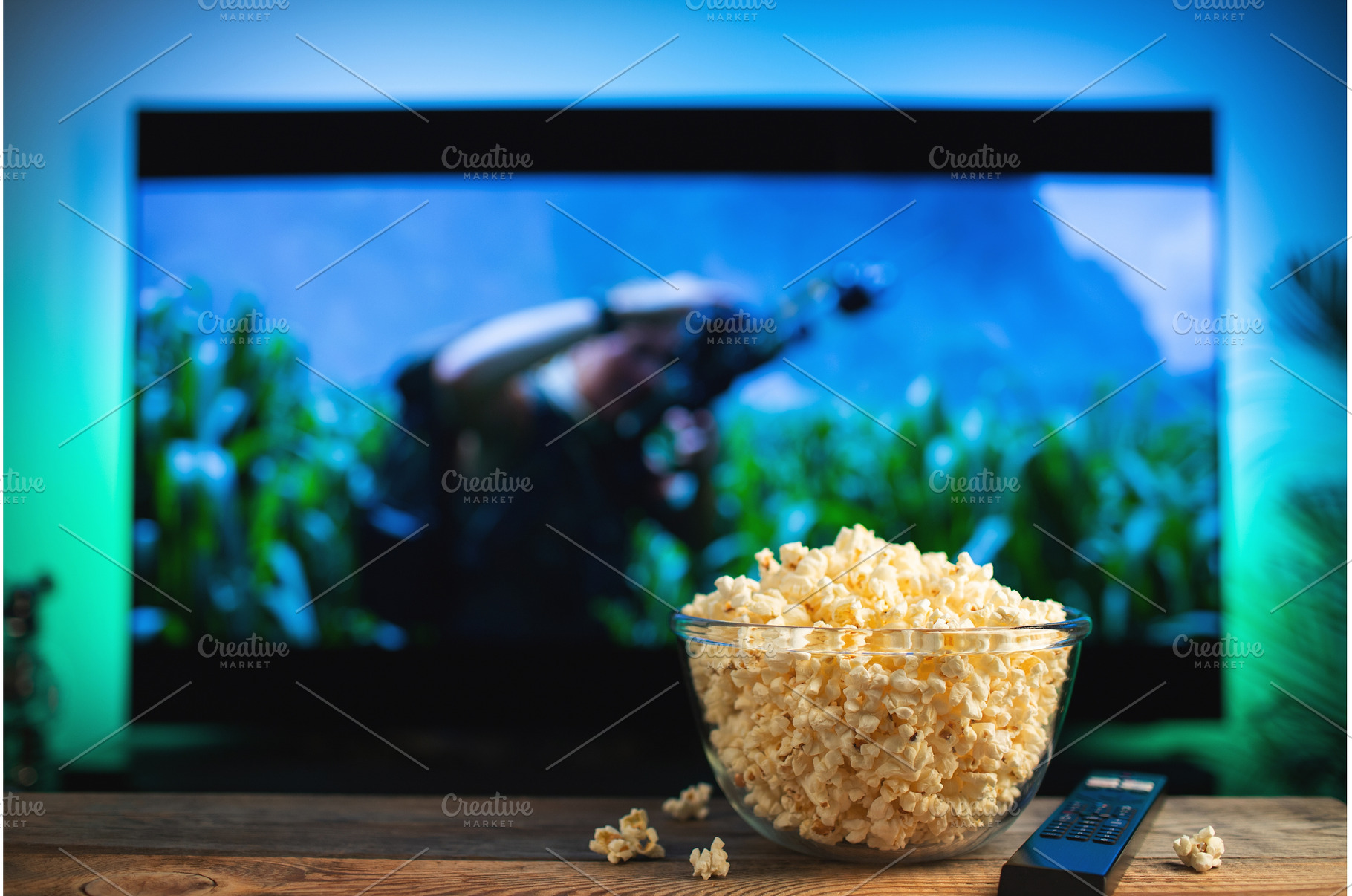 A glass bowl of popcorn and remote, a Technology Photo by Budarinphoto