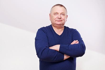 Middle aged man with crossed arms, a Person Photo by Sergey Furtaev