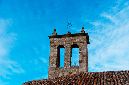 Bell tower of a medieval stone church in the historic town of Atienza, an Architecture Photo by Architect´s eye