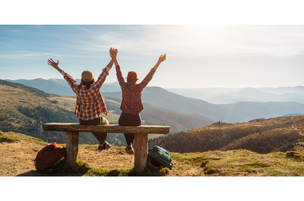 Couple of Hikers With Raised Hands