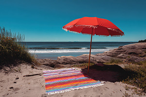 Sunshade and blanket set up on sandy, a Photo by Pavel_design