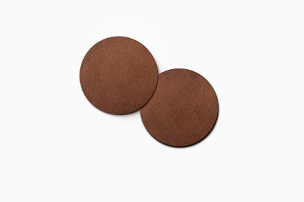two dark brown leather coaster, a Photo by UN-BRANDED