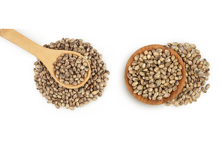 Hemp seeds in wooden spoon isolated, a Food & Drink Photo by NataPhoto