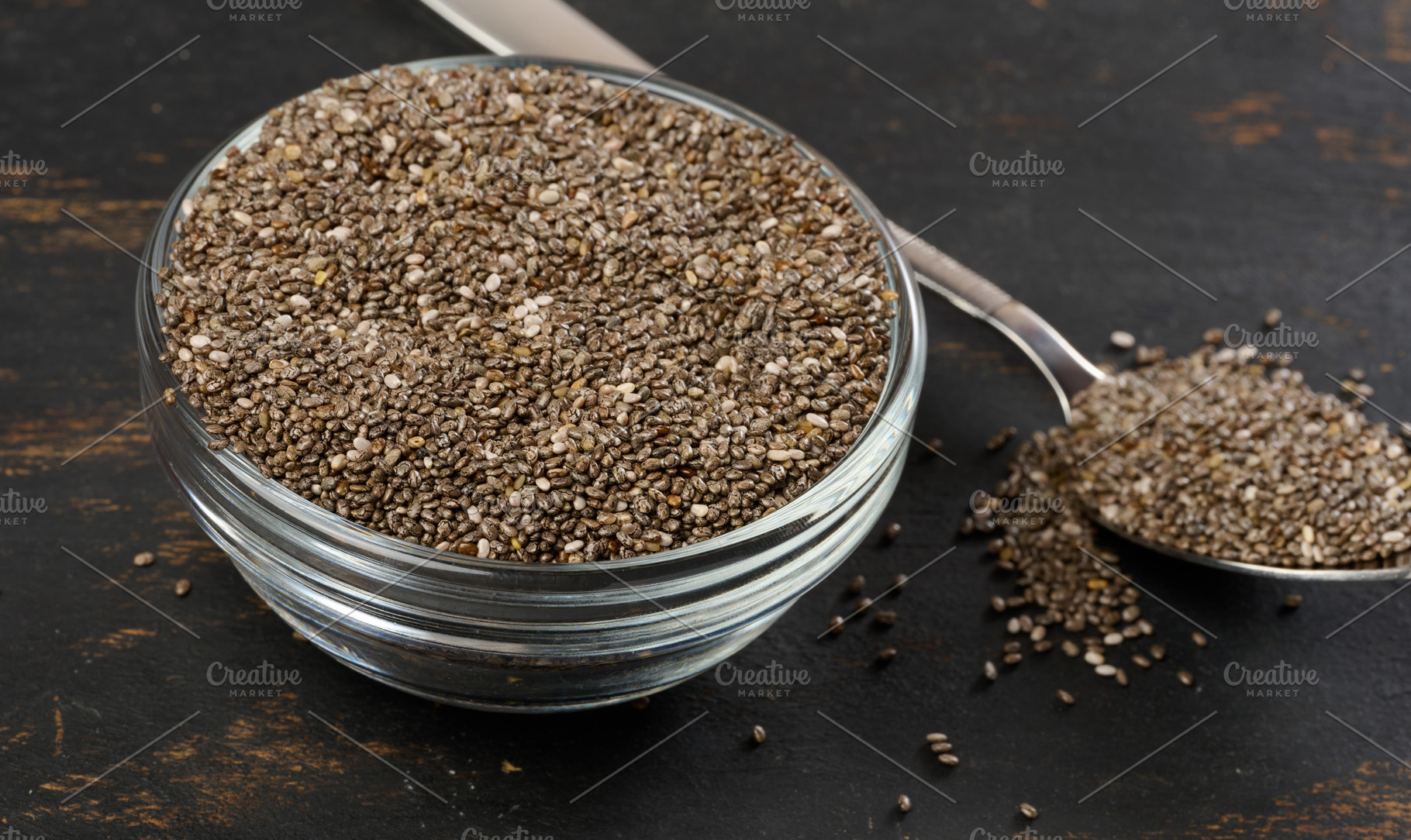 Clear glass bowl filled with dry chia seeds, top view, a Food & Drink Photo by ndanko