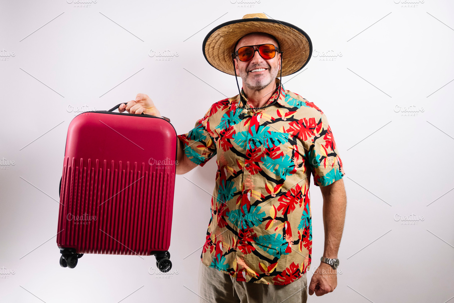 Tourist with suitcase and winning gesture, a Holiday Photo by karrastock