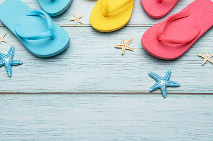 Colorful flip flops and starfish creating summer vacation atmosp