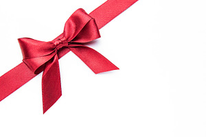 Red ribbon and bow creating a festive design, a Holiday Photo by Olena Rudo
