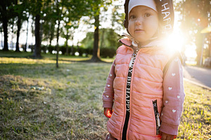 Young child in a park enjoying nature on a sunny day, a Photo by AS photostudio