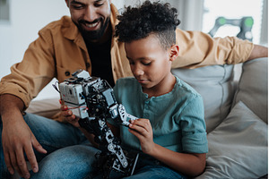 Father teaching son about STEM, a Technology Photo by HalfPoint