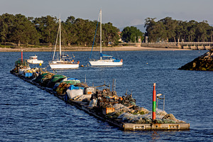 Nets and motors on a floating artisa, an Industrial Photo by Perpis