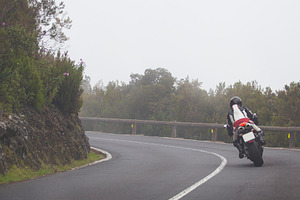 Motorcyclist riding on winding mountain road in fog, dynamic bik, a Photo by Pictures for you!!!!!!!!!