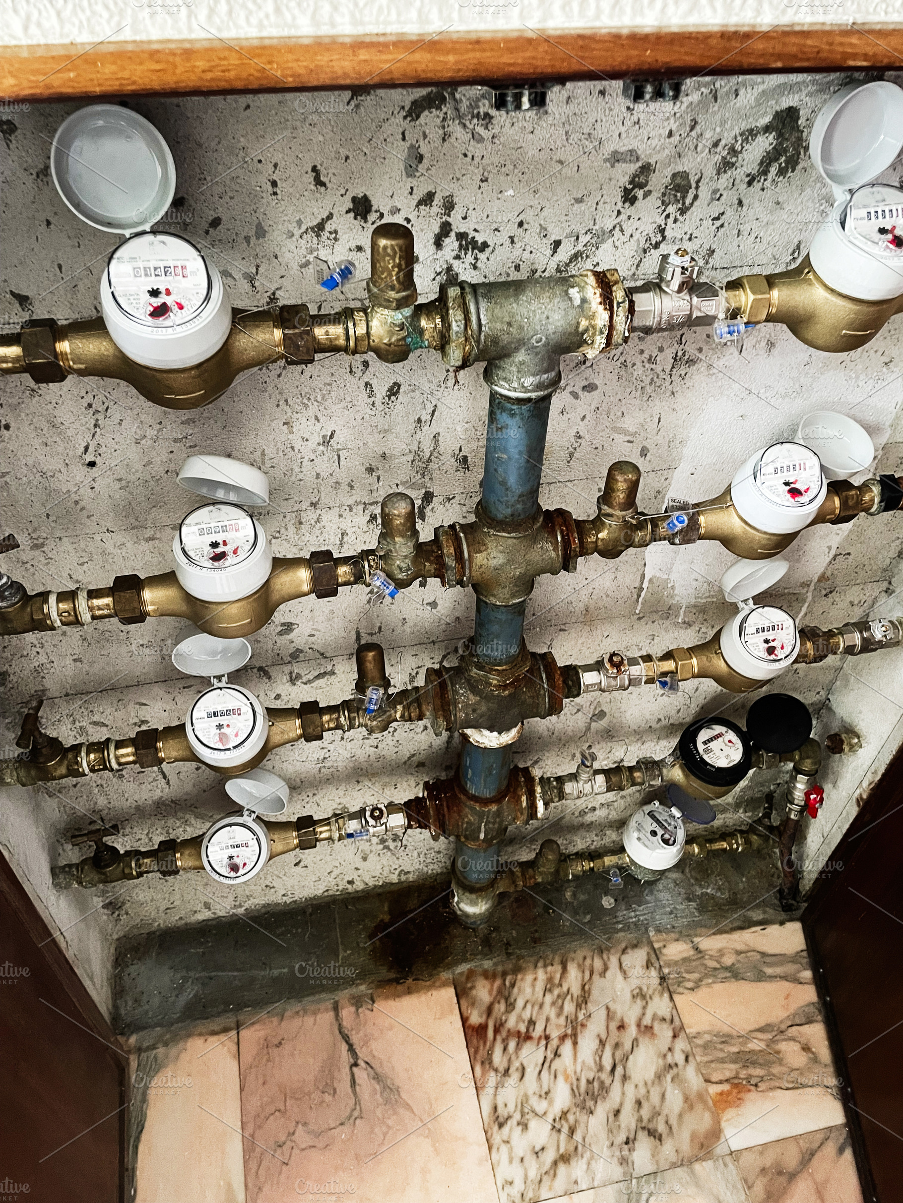 Water meter system in residential building in Lisbon, Portugal, detailed view, a Photo by AS photostudio
