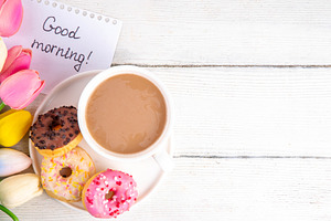 Small sugar glazed donuts with coffee latte cup, tulip flowers,, a Holiday Photo by Rimma