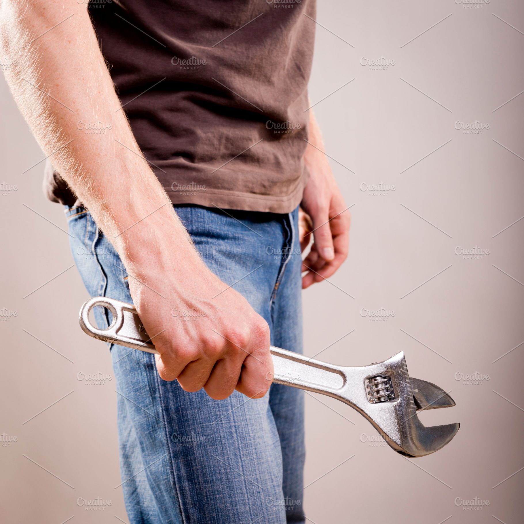 Man Holding Adjustable Wrench, an Industrial Photo by THP Creative