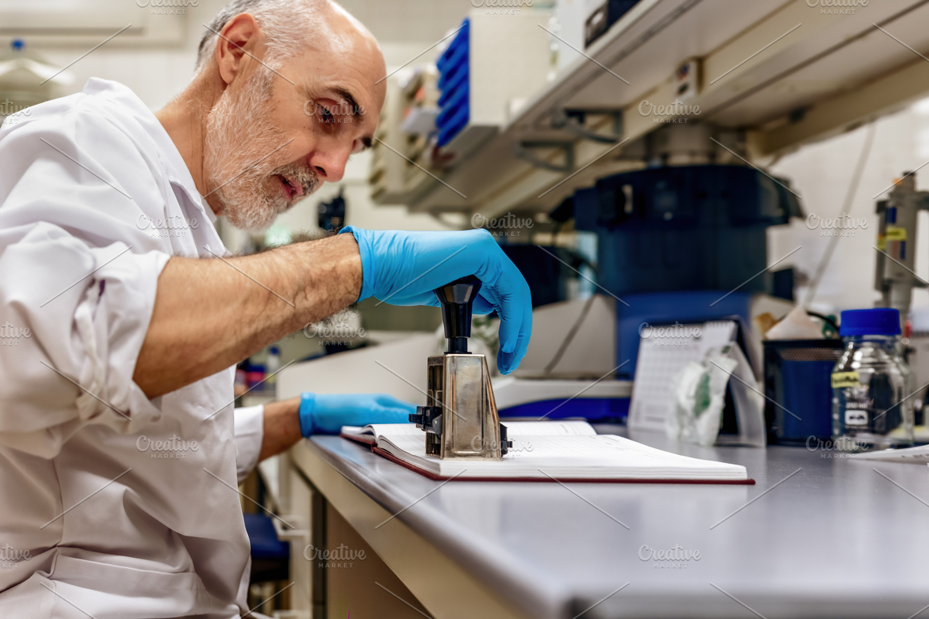 Scientist using a stamp in a laborat, a Health & Medical Photo by Perpis
