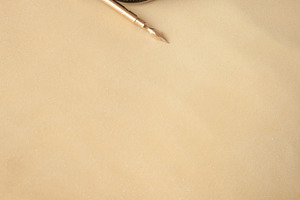 Golden quill pen on parchment
