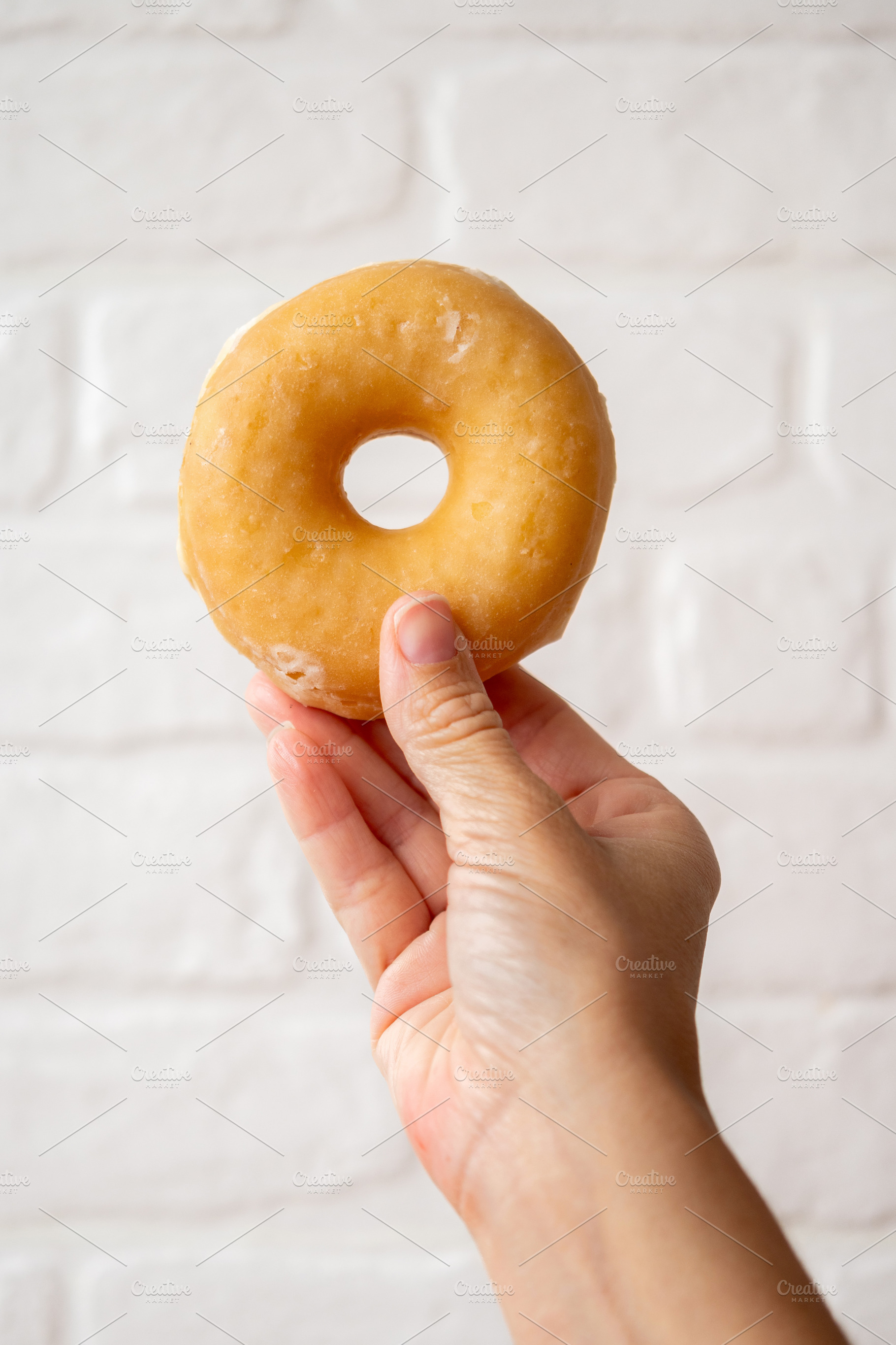 Hand Holding Glazed Donut, a Food & Drink Photo by etorres69