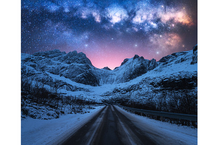 Milky Way over road, snowy mountains