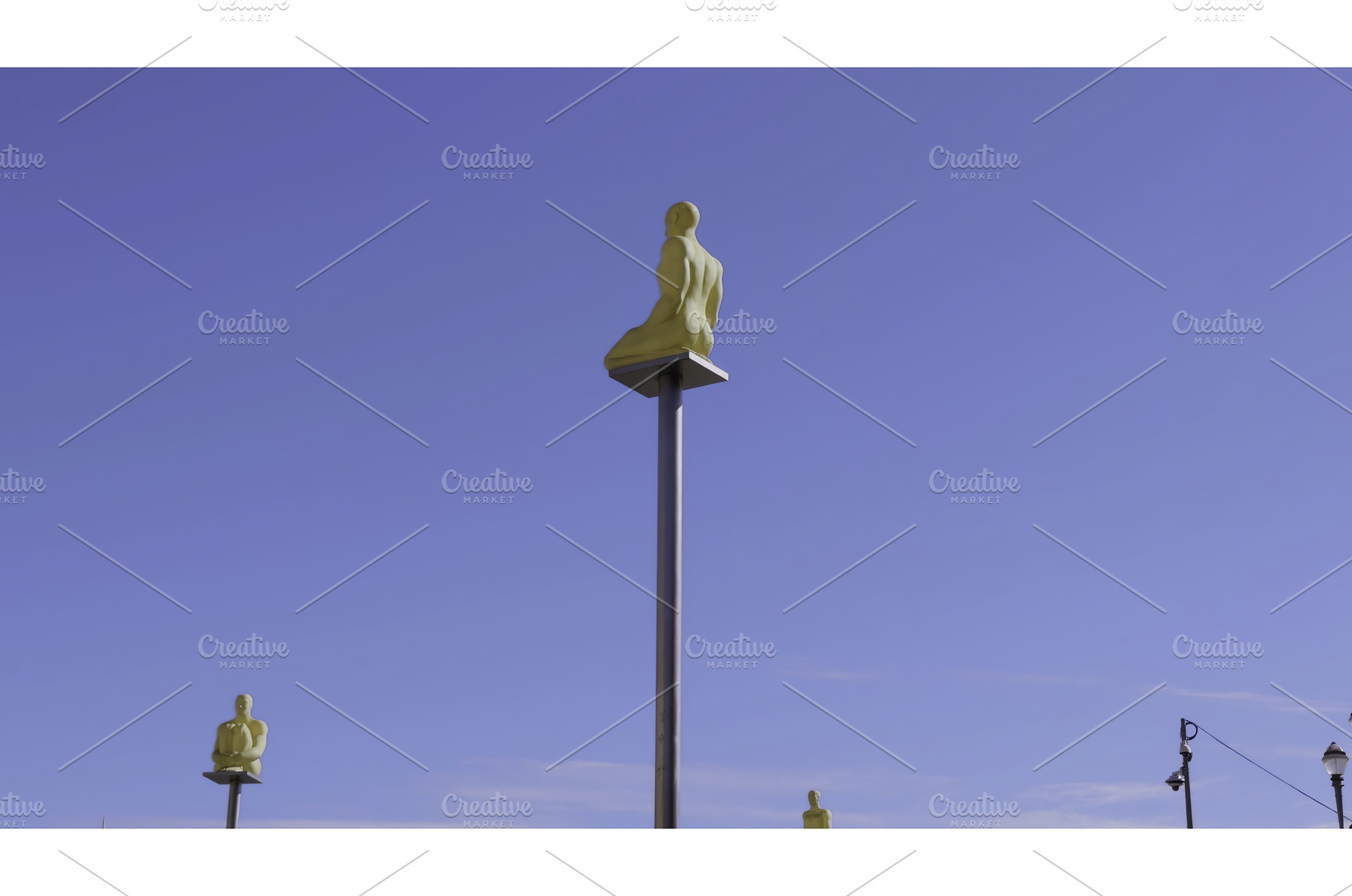 Golden statues sitting on poles, an Architecture Photo by Media Whale Stock