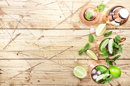 Moscow mule cocktails in copper mug with lime, ice, ginger beer,, a Food & Drink Photo by 5PH