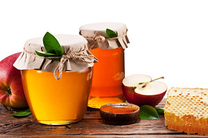 Glass cans full of honey, apples and honeycombs. Clipping paths., a Food & Drink Photo by Volff