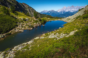 Alpine lake and high snowy mountains, a Nature Photo by Alpine Dreams