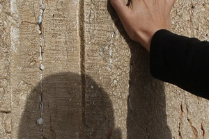 Male hand on a Western wall