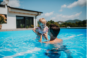 Father and young daughter playing in, a Person Photo by HalfPoint