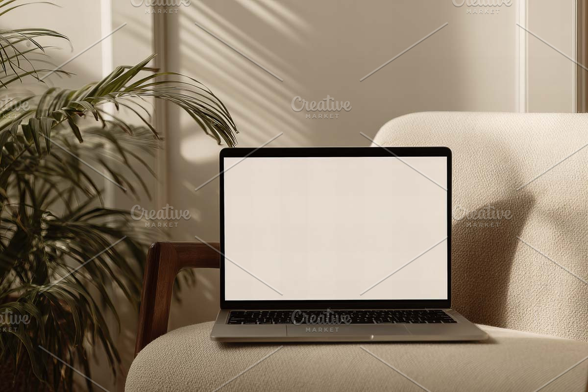 laptop display on sofa in mode, a Mac Mockup by VetalStock