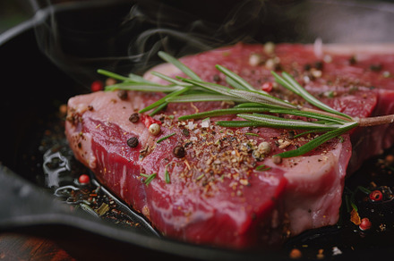 A thick cut of steak is generously s, a Photo by Tanuart