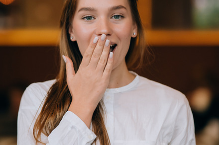 Headshot portrait of smiling young woman. Close up.