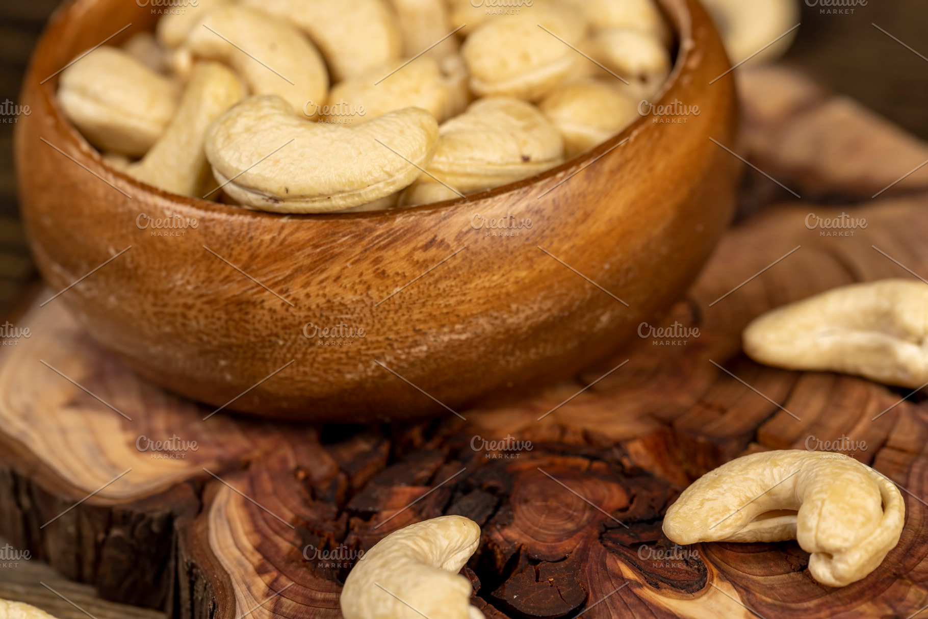 large cashew nuts are scattered on a larch board, a Photo by rsoollAI
